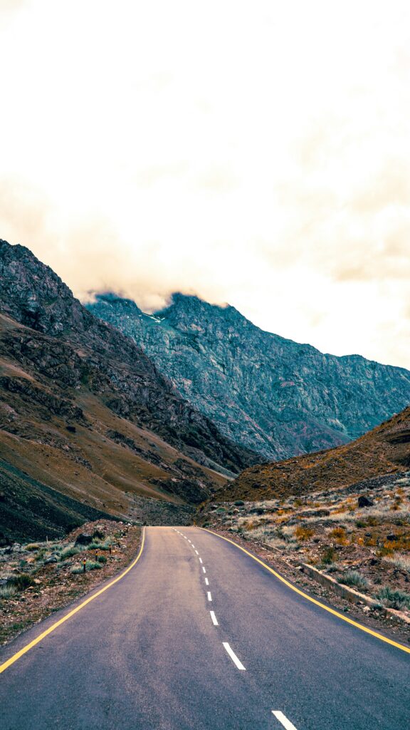 A scenic view of a deserted mountain road winding through the breathtaking landscapes of Kargil, Ladakh.